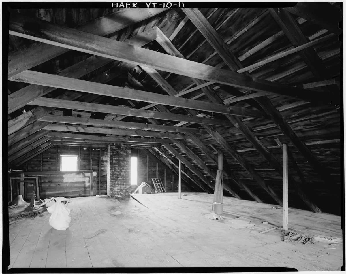 Weatherstripping and rigid foam insulation laid out next to an attic hatch